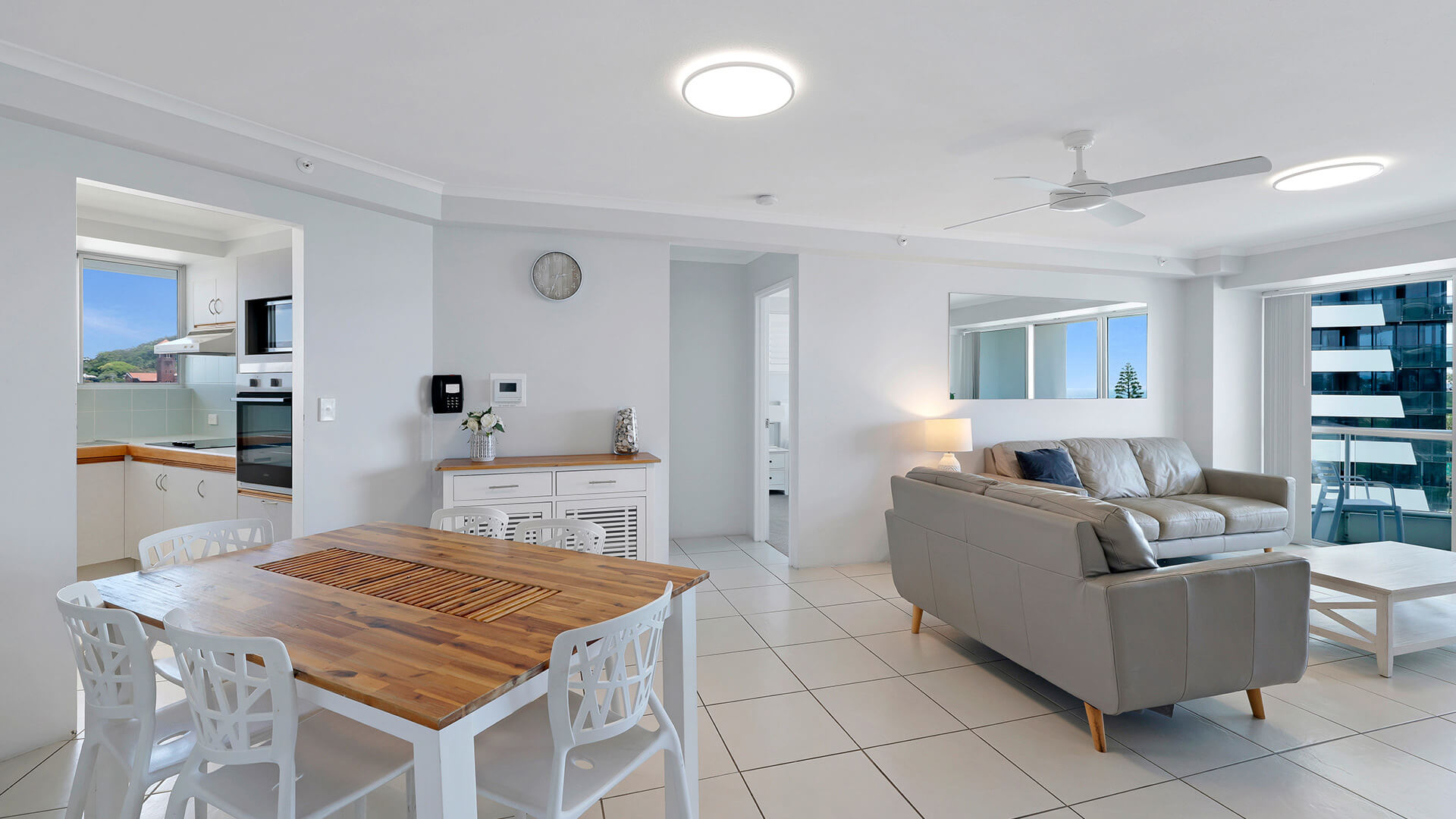 Open-plan living and dining area in the Standard 2 Bedroom Centre Front Apartment at ULTIQA Points North, with access to the balcony.