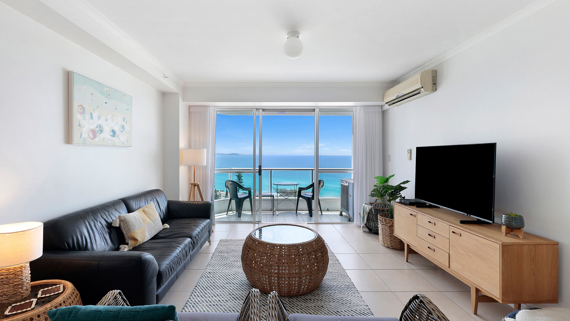 Living area of the Standard 2 Bedroom Ocean View Apartment at ULTIQA Points North, featuring a balcony with ocean views.
