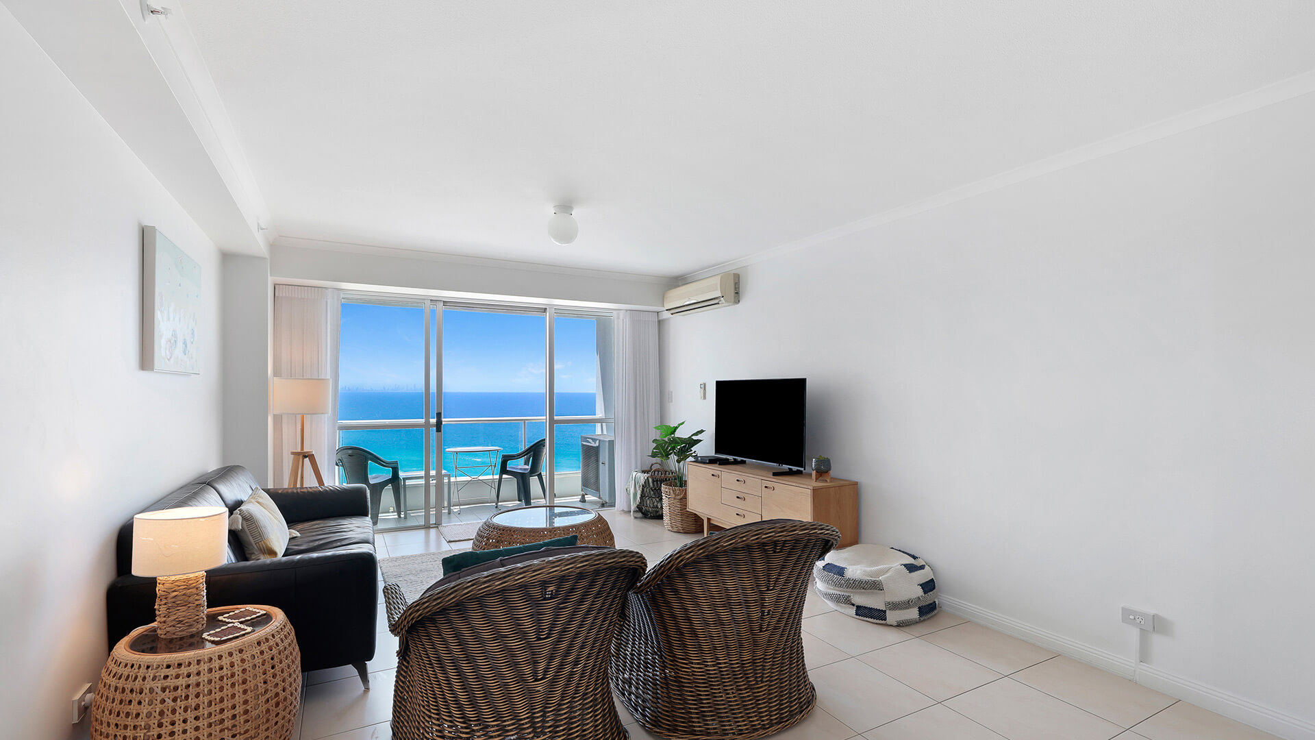 Bright living room in the Standard 2 Bedroom Ocean View Apartment at ULTIQA Points North, with a balcony overlooking the ocean.
