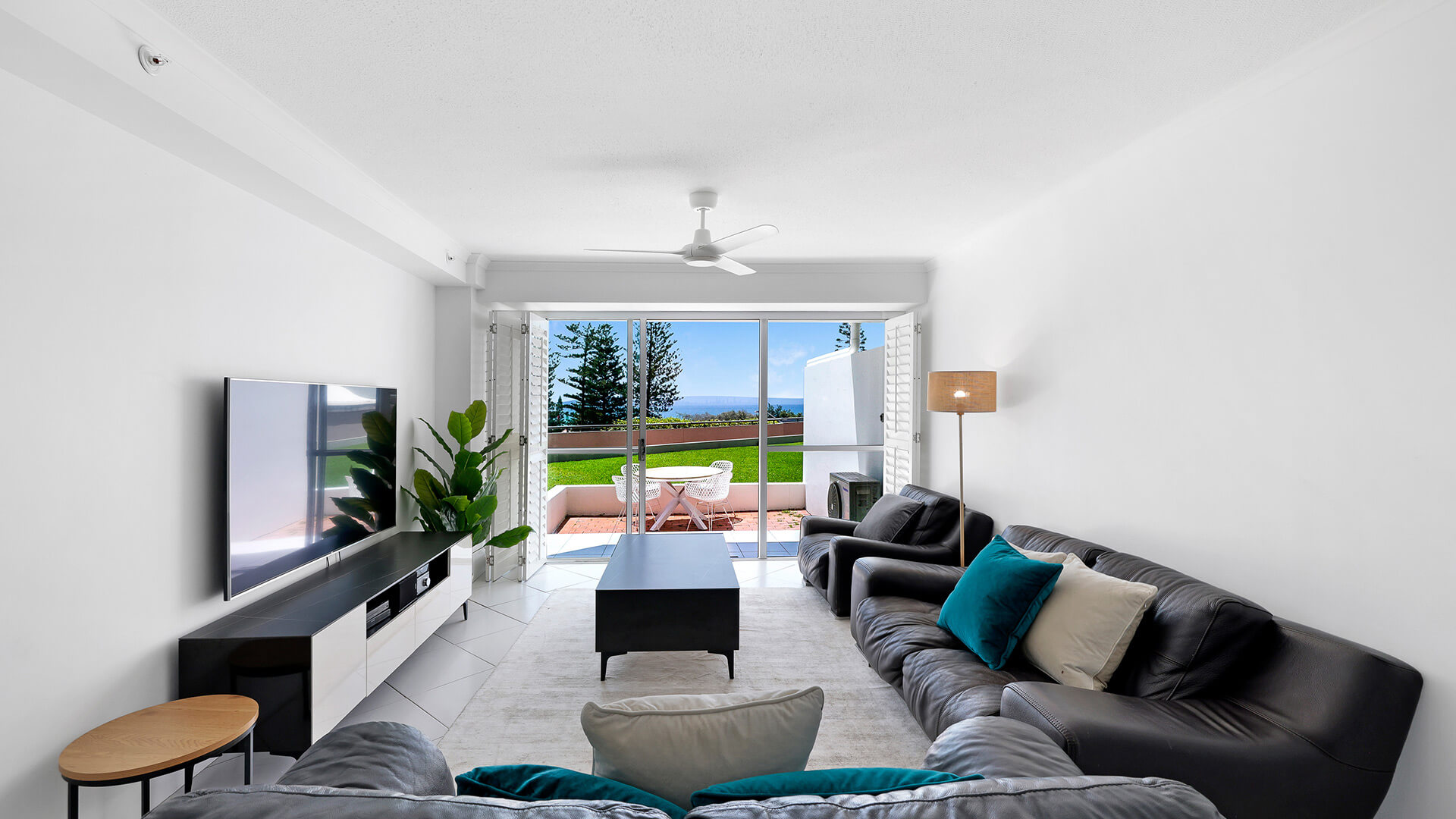 Living area in the Superior 2 Bedroom Courtyard Apartment at ULTIQA Points North, opening onto a private courtyard with ocean glimpses.