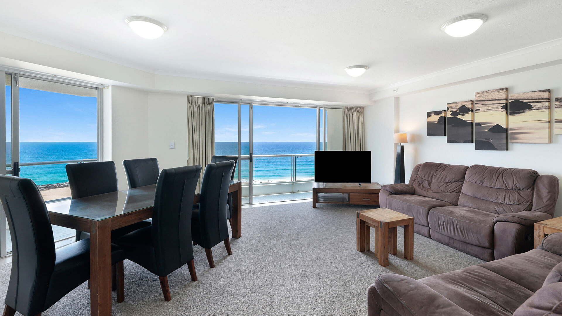 Spacious oceanfront living and dining area in the Deluxe 2 Bedroom Centre Front Apartment at ULTIQA Points North.