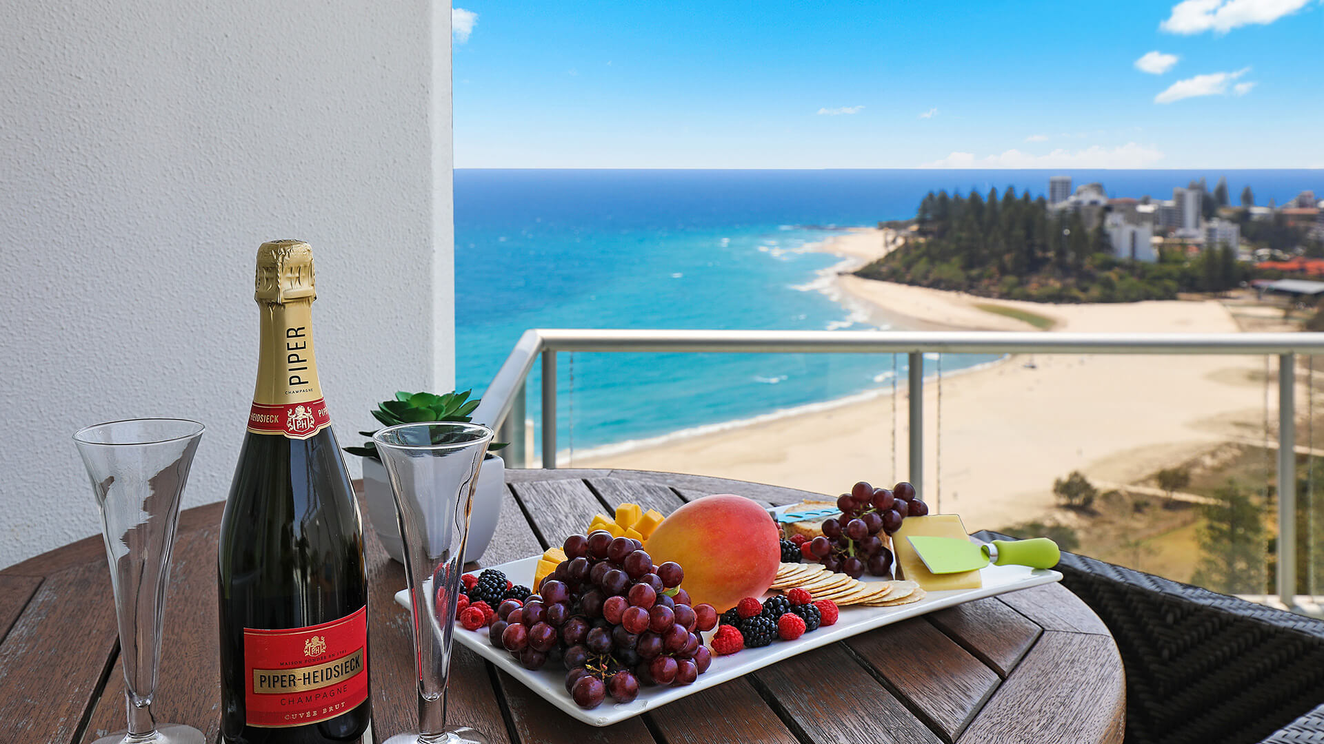Champagne and fruit platter on the balcony of the 4 Bedroom Oceanfront Penthouse at ULTIQA Points North overlooking the beach.