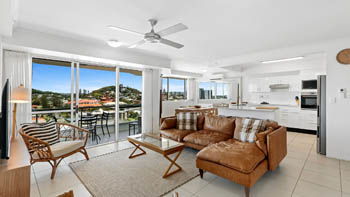 Open-plan living and dining area in the 2 Bedroom Pool View Apartment at ULTIQA Points North with modern furnishings and balcony views.