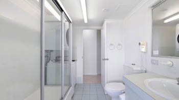 Bathroom and laundry area in the Standard 2 Bedroom Ocean View Apartment at ULTIQA Points North, featuring a shower and vanity.