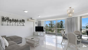 Spacious living and dining area with ocean views in the Standard 2 Bedroom Centre Front Apartment.