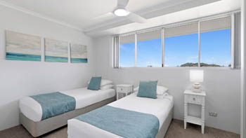 Twin bedroom in the Standard 2 Bedroom Centre Front Apartment at ULTIQA Points North, with natural light and coastal décor.