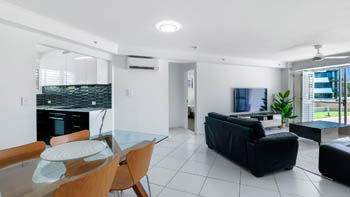 Dining and living area in the Superior 2 Bedroom Courtyard Apartment at ULTIQA Points North, featuring modern finishes and courtyard access.