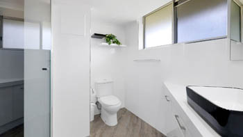 Modern bathroom in the Superior 2 Bedroom Courtyard Apartment at ULTIQA Points North, featuring a walk-in shower and contemporary vanity.