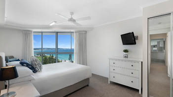 Master bedroom in the Superior 2 Bedroom Ocean View Apartment at ULTIQA Points North, featuring stunning ocean and coastline views.