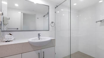 Modern bathroom in the Deluxe 2 Bedroom Centre Front Apartment at ULTIQA Points North with walk-in shower.