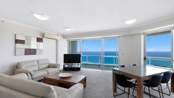 Ocean-view living and dining area in the Deluxe 2 Bedroom Centre Front Apartment at ULTIQA Points North.