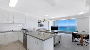 Open-plan kitchen, living and dining area with ocean views in the Deluxe 2 Bedroom Centre Front Apartment at ULTIQA Points North.