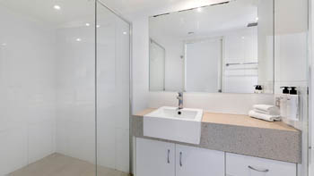 Spacious modern bathroom with walk-in shower in the Deluxe 2 Bedroom Centre Front Apartment at ULTIQA Points North.