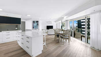 Spacious open-plan kitchen, dining & living area with balcony access in a Deluxe 3 Bedroom Ocean View Apartment at ULTIQA Points North Coolangatta.