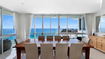 Dining area of the 4 Bedroom Oceanfront Penthouse at ULTIQA Points North with ocean and coastline views.