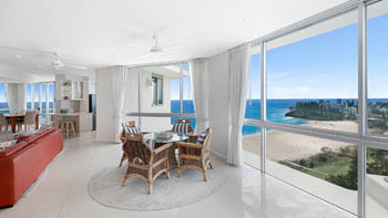 Casual sitting area of the 4 Bedroom Oceanfront Penthouse at ULTIQA Points North with views over the beach and ocean.