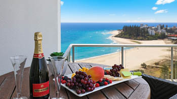 Champagne and fruit platter on the balcony of the 4 Bedroom Oceanfront Penthouse at ULTIQA Points North overlooking the beach.
