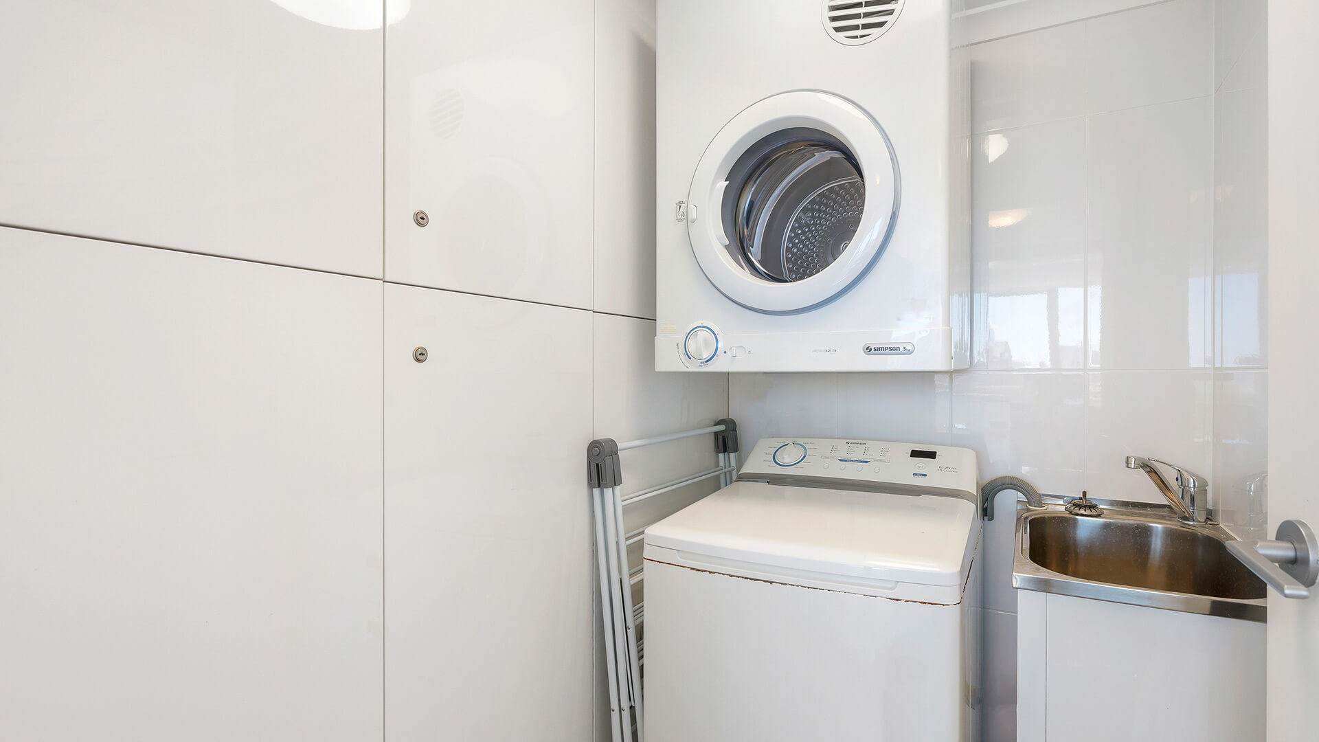 In-apartment laundry with washer, dryer and sink at ULTIQA Beach Haven, Surfers Paradise