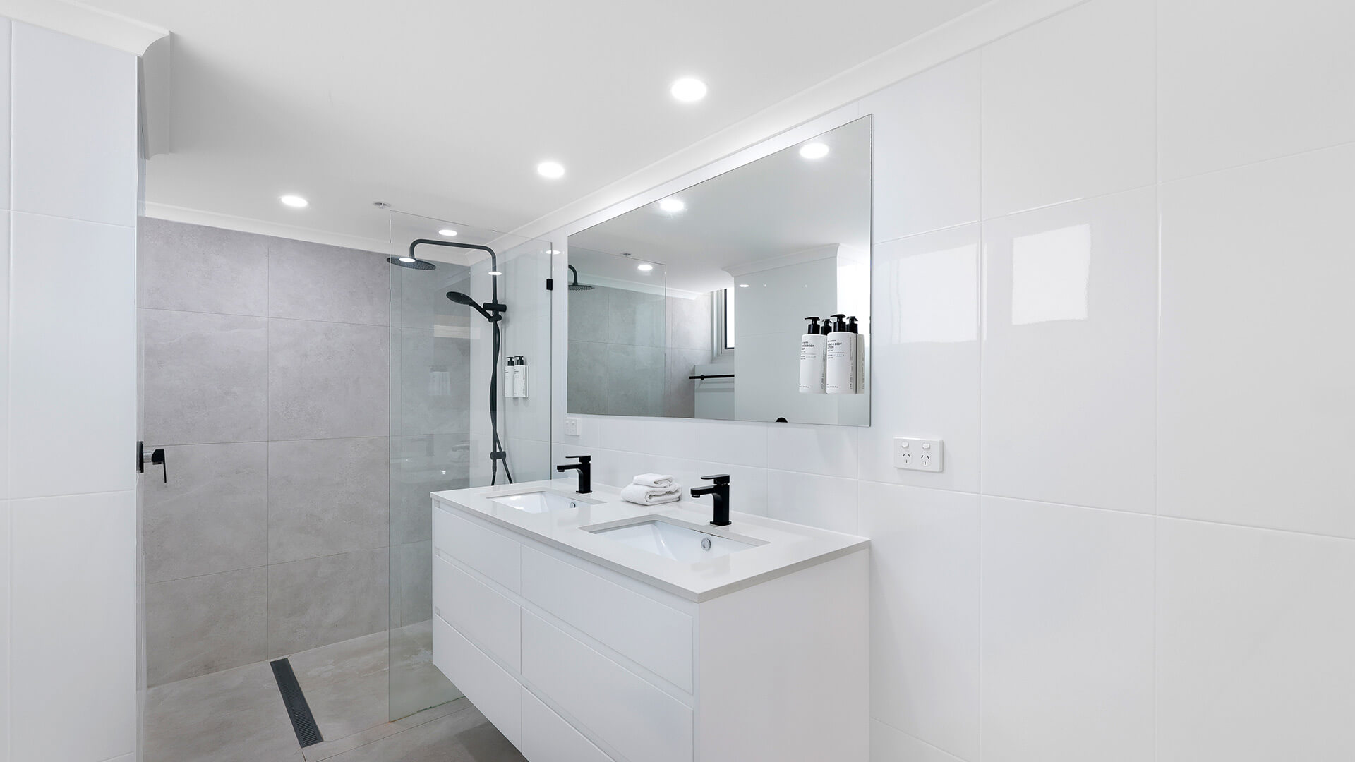 Modern bathroom with double vanity and walk-in shower at ULTIQA Beach Haven, Surfers Paradise apartment