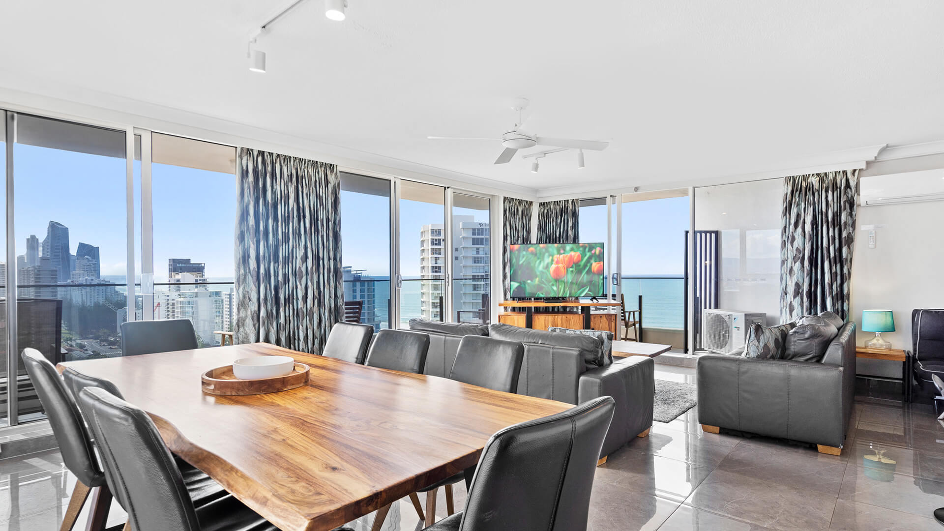 Dining room with living area in the background and views of the Gold Coast at ULTIQA Beach Haven.