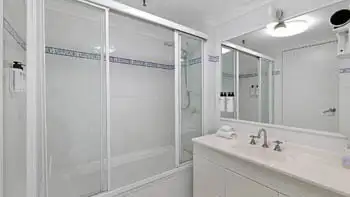 Second bathroom with shower-over-bath and vanity in the 2 Bedroom Apartment at ULTIQA Beach Haven on Broadbeach.