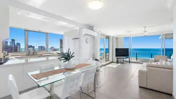 Bright and spacious open-plan living, dining, and kitchen area in the 2 Bedroom Ocean View Apartment at ULTIQA Beach Haven on Broadbeach with panoramic ocean views and modern furnishings.