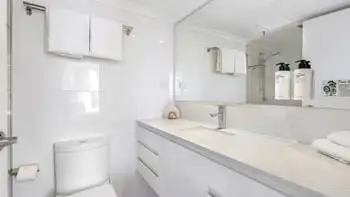 Modern bathroom in the 2 Bedroom Ocean View Apartment at ULTIQA Beach Haven on Broadbeach featuring a large vanity, walk-in shower, and complimentary toiletries.