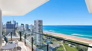 Private balcony in the 2 Bedroom Ocean View Apartment at ULTIQA Beach Haven on Broadbeach, overlooking the Gold Coast coastline with outdoor seating and sweeping views of the beach, ocean, and city sk