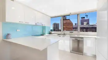 Fully equipped kitchen in the 2 Bedroom Ocean View Apartment at ULTIQA Beach Haven on Broadbeach with modern appliances and city views.
