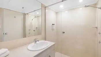 Second bathroom in the 2 Bedroom Ocean View Apartment at ULTIQA Beach Haven on Broadbeach with shower over bath and modern vanity.