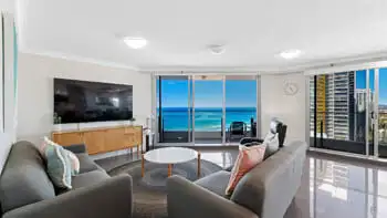 Bright and spacious living area in the Premium 2 Bedroom Ocean View Apartment at ULTIQA Beach Haven on Broadbeach with ocean views and access to a private balcony.