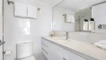 Clean modern bathroom vanity and toilet at ULTIQA Beach Haven on Broadbeach, Gold Coast holiday accommodation.