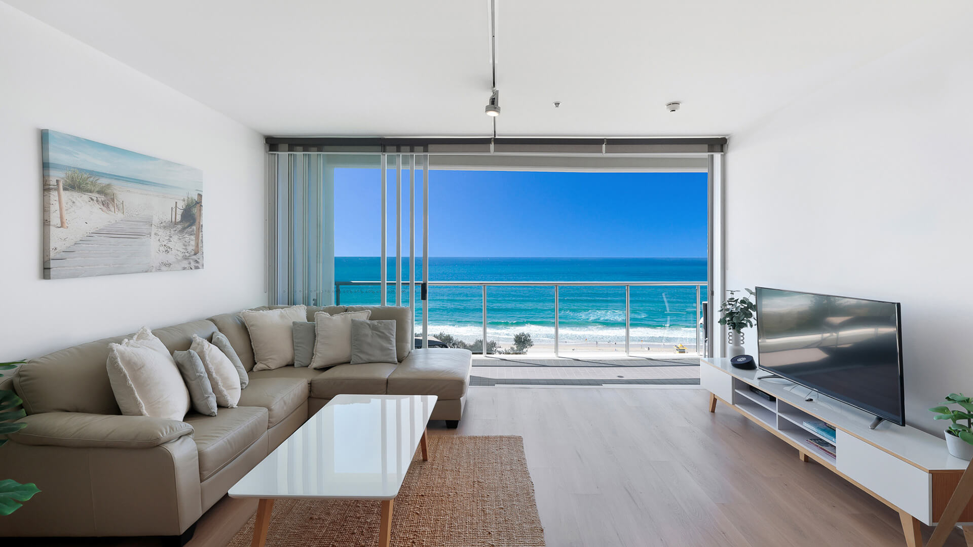 Living room with ocean views and balcony in 1 Bedroom Ocean View Apartment at ULTIQA Air on Broadbeach.
