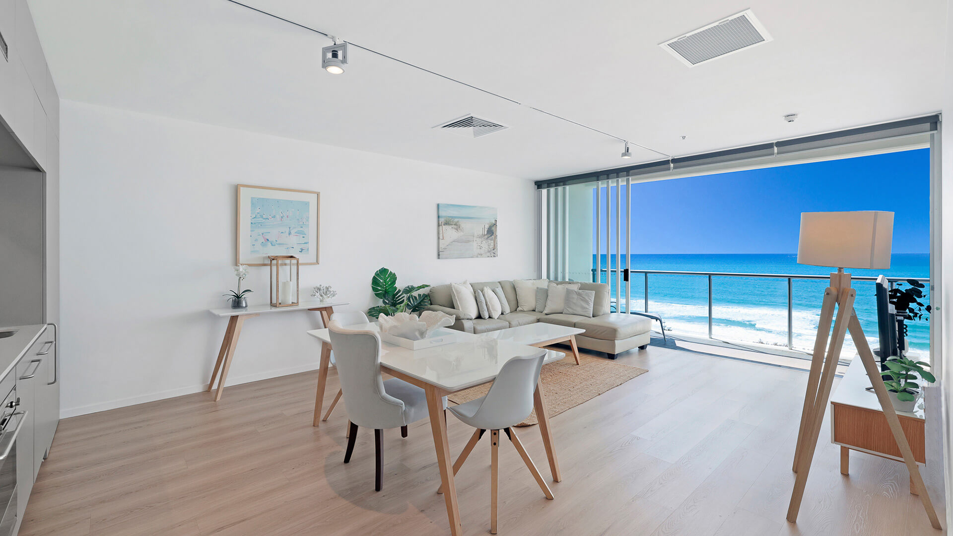 Dining and living area with ocean views in 1 Bedroom Ocean View Apartment at ULTIQA Air on Broadbeach.