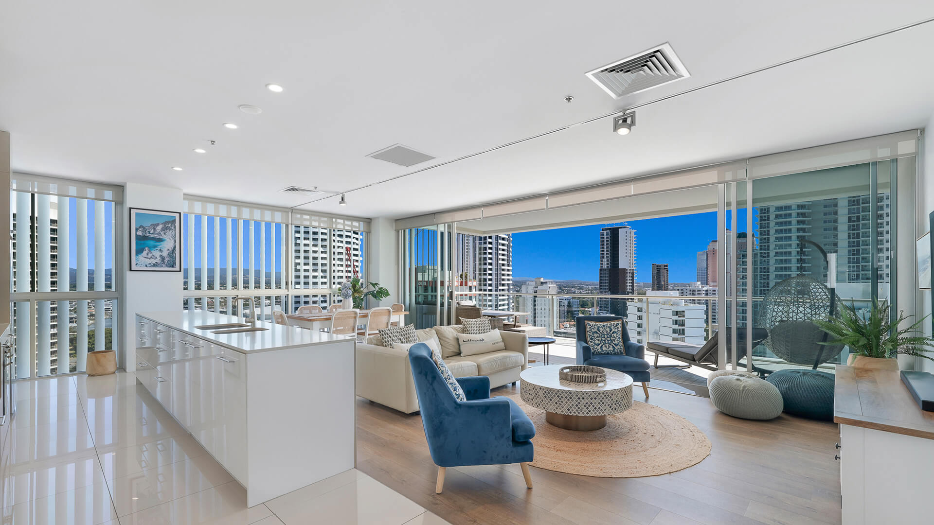 Modern open-plan kitchen and lounge with city views in 2 Bedroom Gold Coast View Suite at ULTIQA Air on Broadbeach.