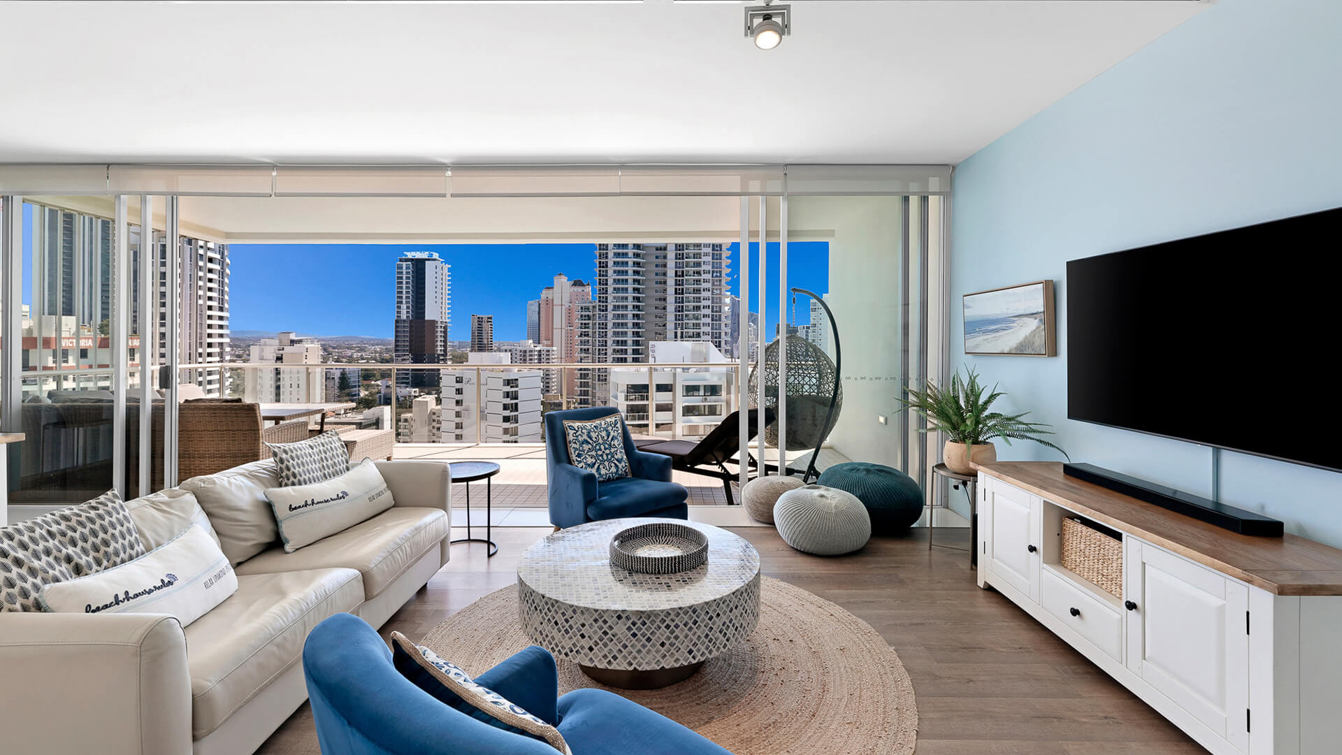 Bright living room with modern furnishings and city views in 2 Bedroom Gold Coast View Suite at ULTIQA Air on Broadbeach.