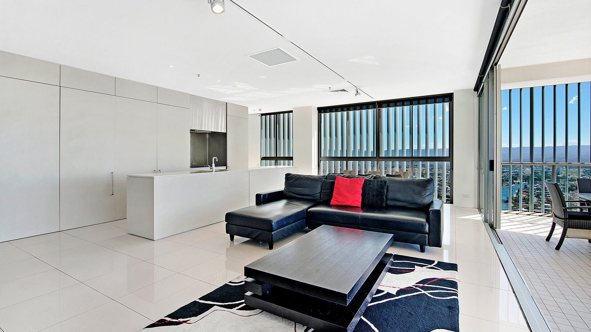 Spacious open-plan living with sleek kitchen, stylish lounge, and expansive views from the 2 Bedroom Gold Coast View Suite at ULTIQA Air on Broadbeach.