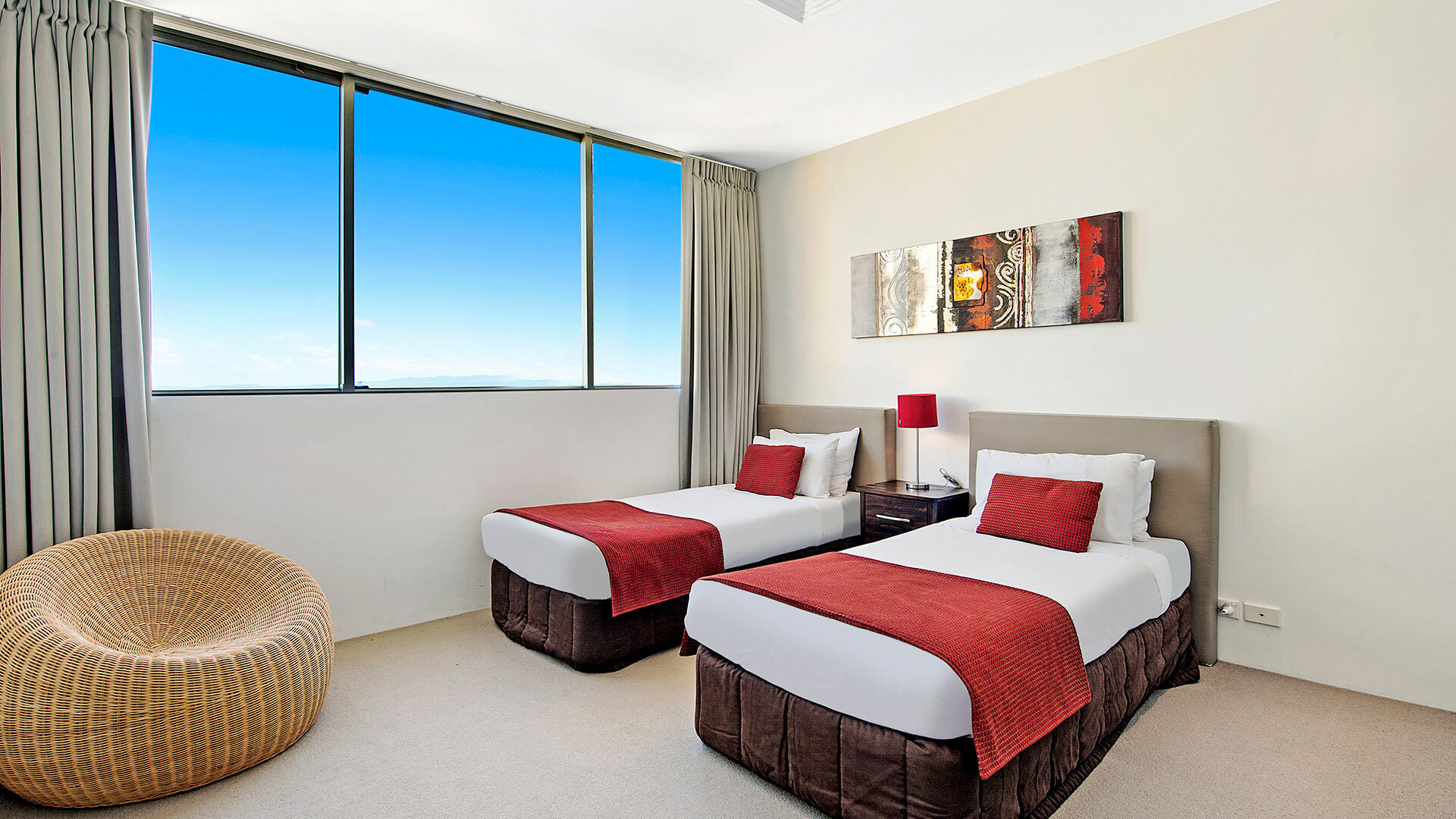 Second bedroom with twin beds and large windows in the 2 Bedroom Gold Coast View Suite at ULTIQA Air on Broadbeach.