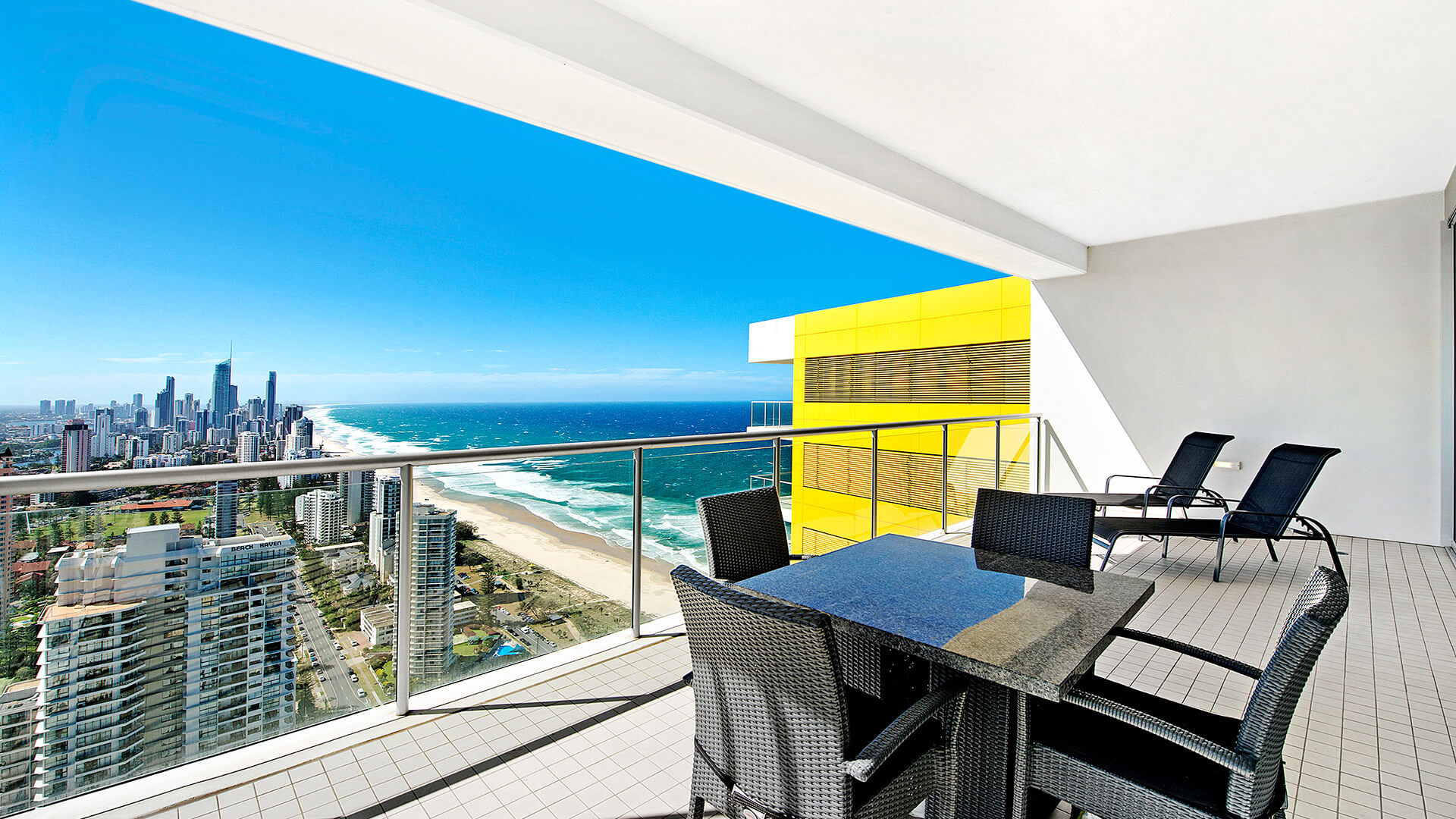 Spacious balcony with outdoor dining and scenic city views from the 2 Bedroom Gold Coast View Suite at ULTIQA Air on Broadbeach.