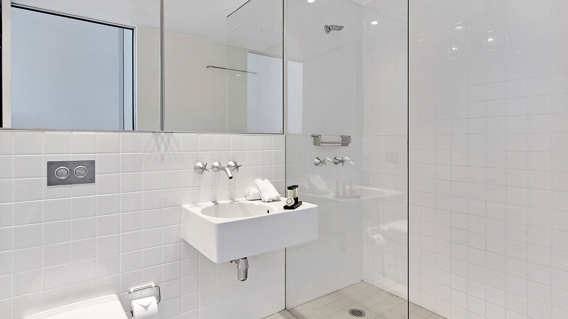 Modern bathroom with walk-in shower, vanity, and contemporary fittings in 2 Bedroom Ocean View Apartment at ULTIQA Air on Broadbeach.