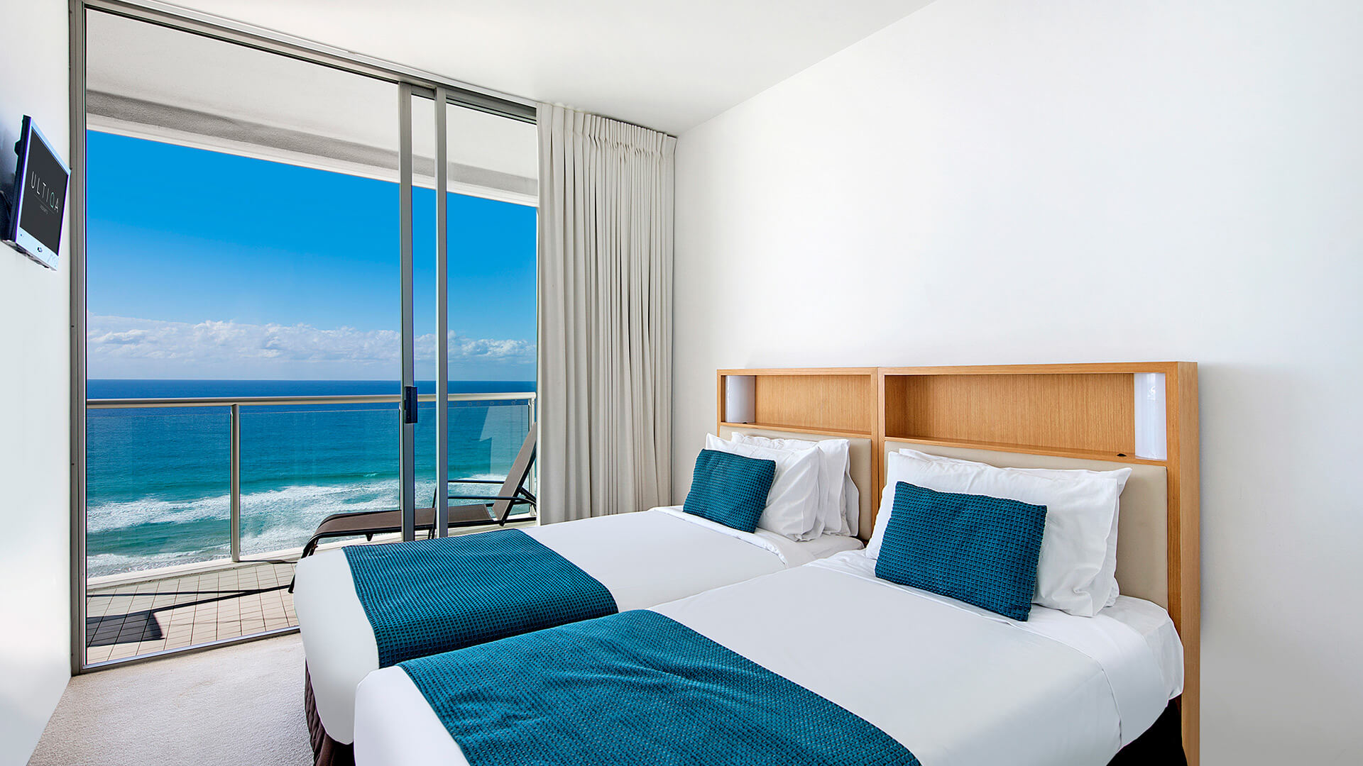 Twin bedroom with ocean views and balcony access in 2 Bedroom Ocean View Apartment at ULTIQA Air on Broadbeach.