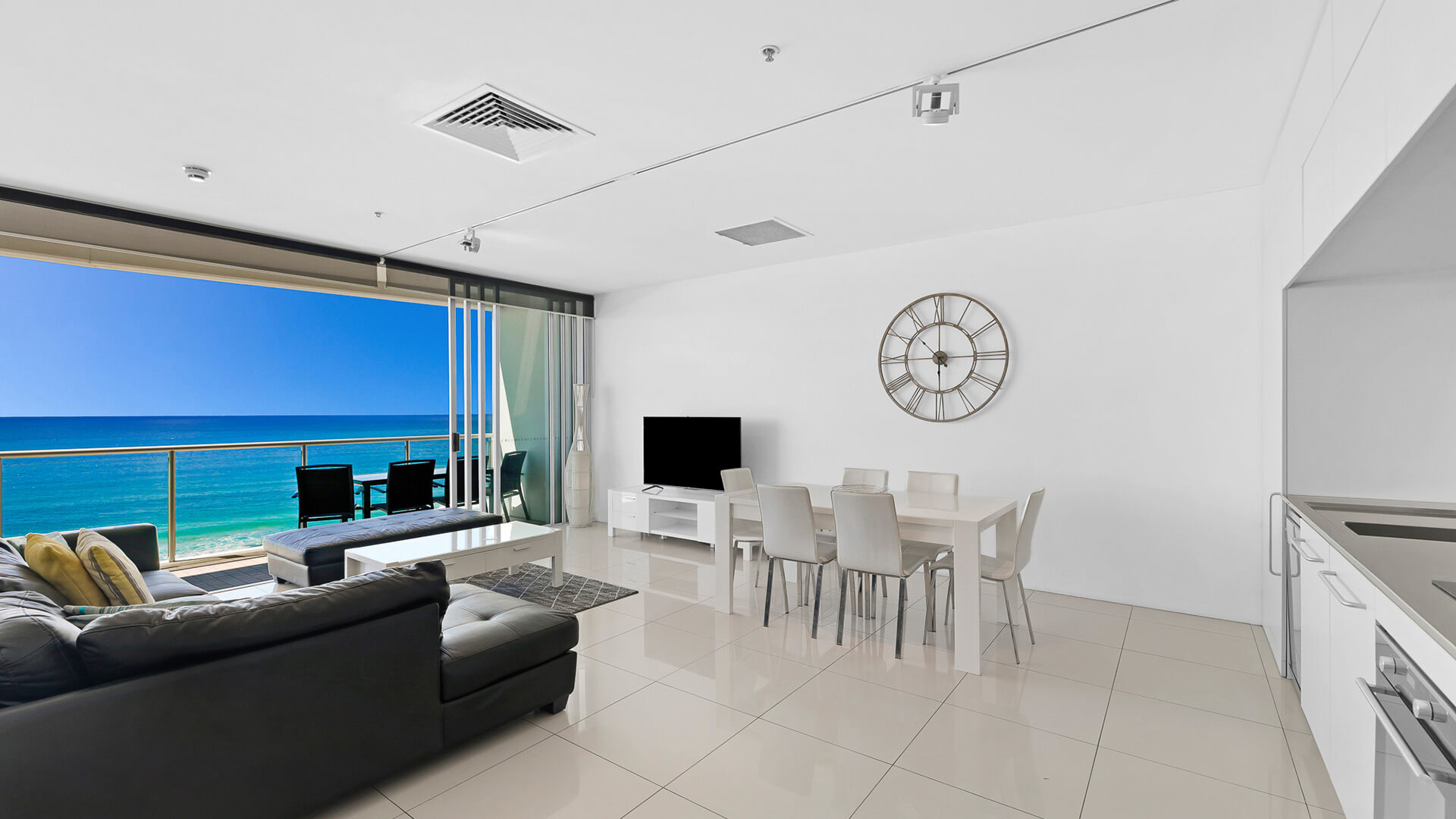 Open-plan living and dining area with ocean views in 2 Bedroom Ocean View Apartment at ULTIQA Air on Broadbeach.