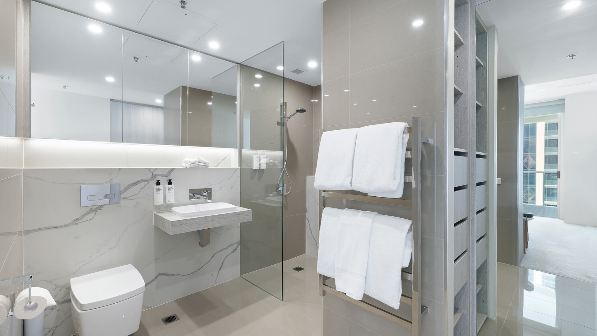 Modern bathroom with walk-in shower and vanity in 2 Bedroom Ocean View Suite at ULTIQA Air on Broadbeach.