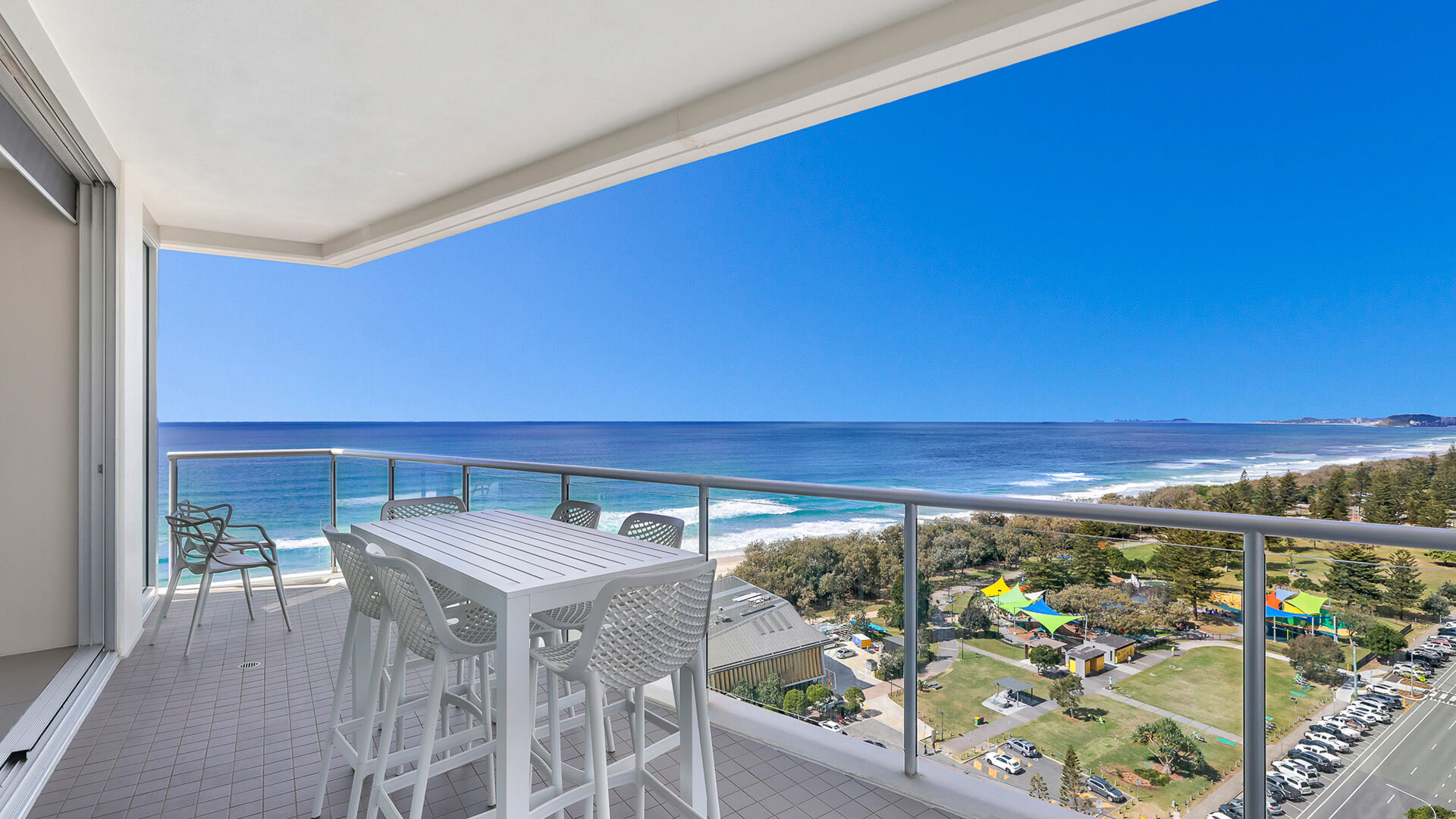 Spacious balcony with outdoor dining and sweeping ocean views from 2 Bedroom Ocean View Suite at ULTIQA Air on Broadbeach.