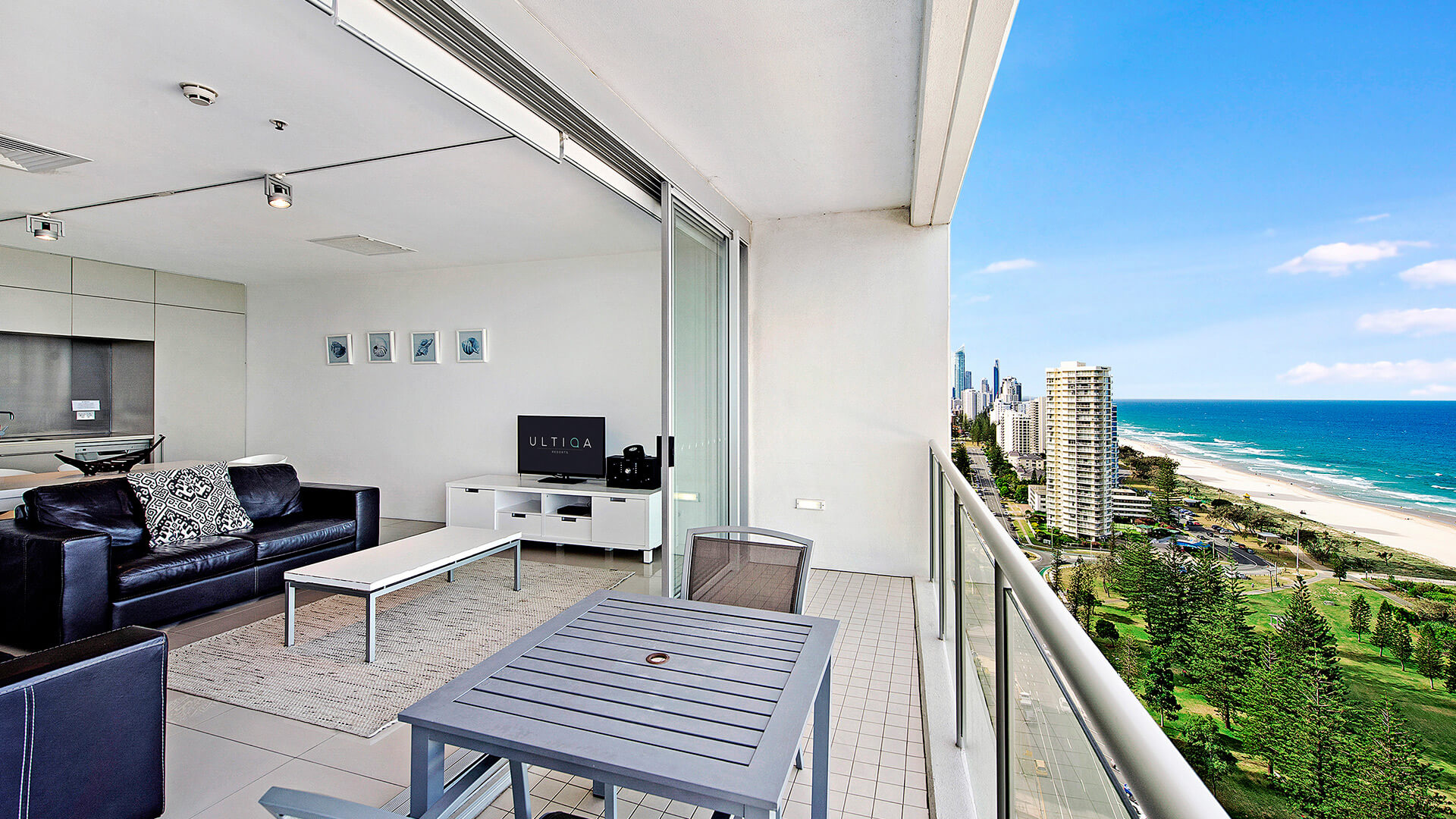 Balcony with outdoor dining and city to ocean views in 2 Bedroom Ocean View Suite at ULTIQA Air on Broadbeach.