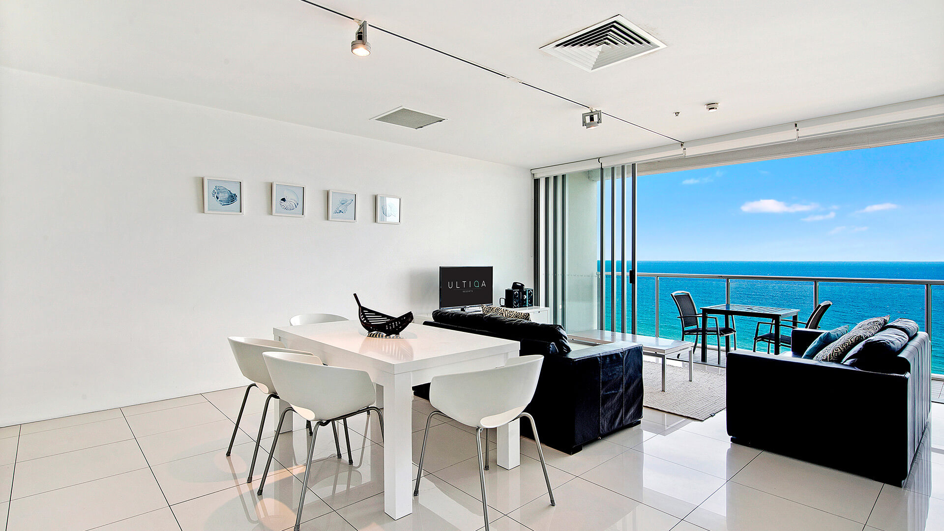 Open-plan dining and living area with ocean views from 2 Bedroom Ocean View Suite at ULTIQA Air on Broadbeach.