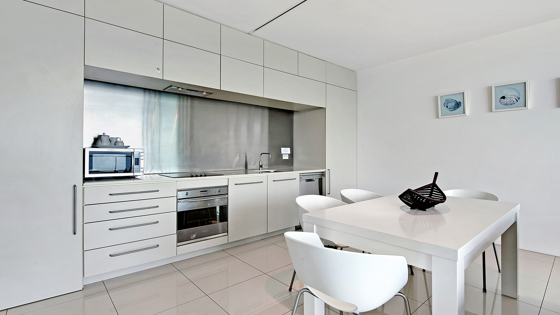 Fully equipped kitchen and dining area in 2 Bedroom Ocean View Suite at ULTIQA Air on Broadbeach.