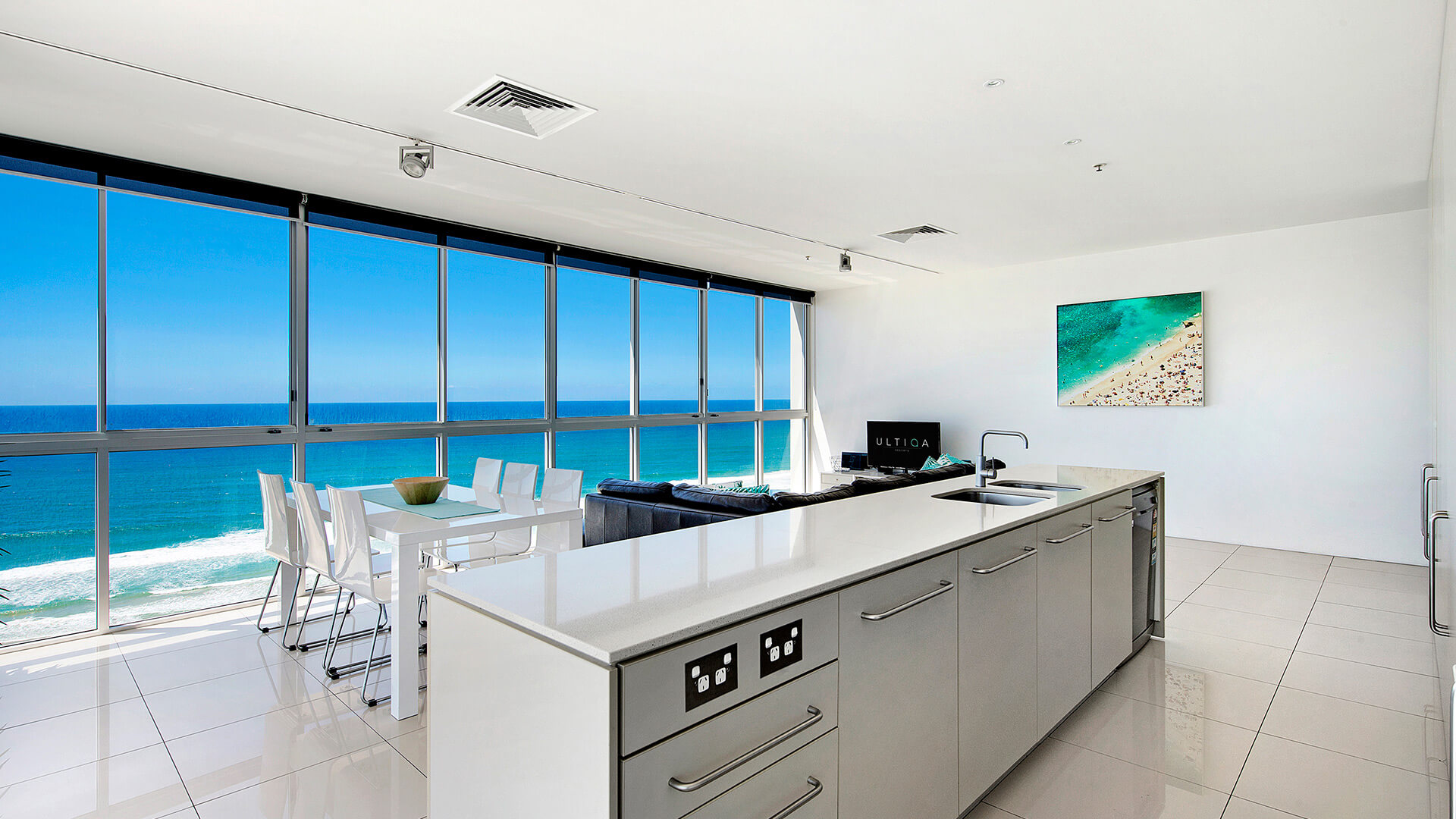 Kitchen and dining area with floor-to-ceiling ocean views in 3 Bedroom Apartment at ULTIQA Air on Broadbeach.