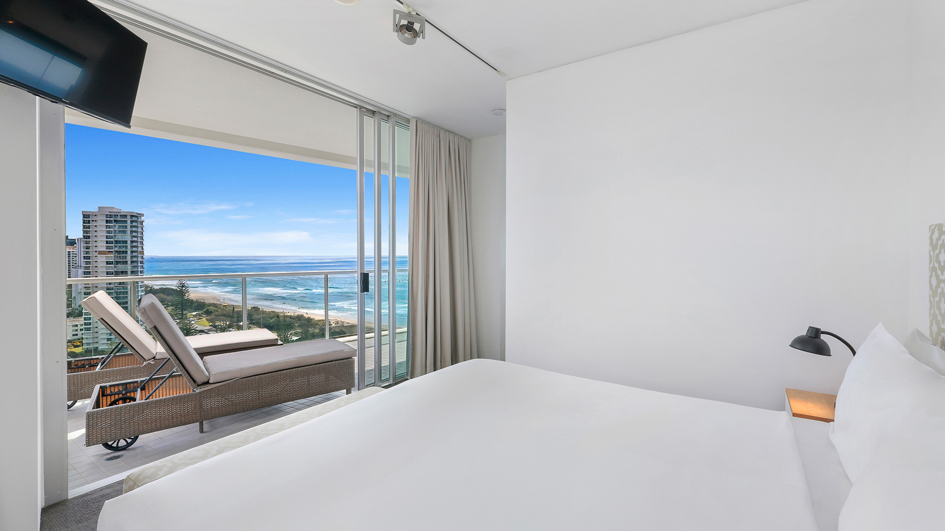 Bedroom in 3 Bedroom Ocean View Apartment at ULTIQA Air on Broadbeach with balcony and ocean views.