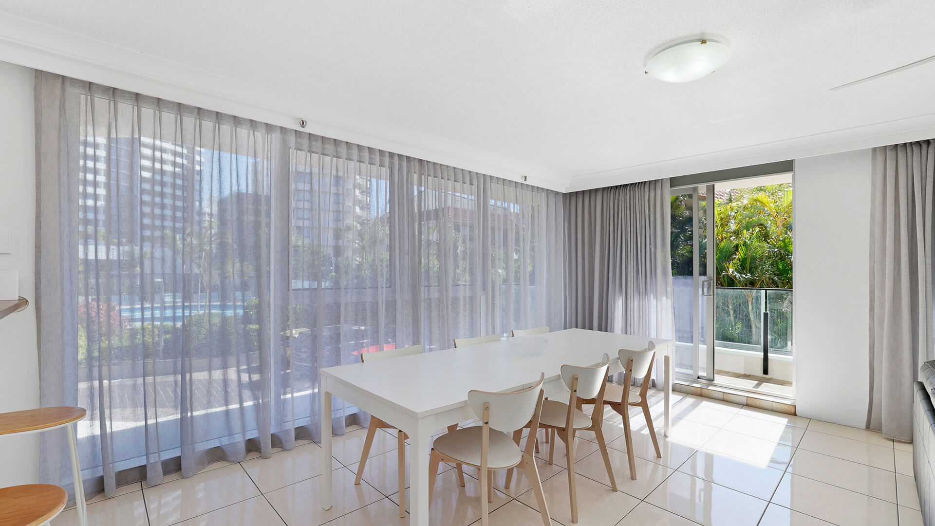 Dining area with seating for eight and large windows in the 2 Bedroom Apartment at ULTIQA Beach Haven.